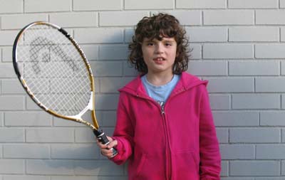 Zoe prepares to play tennis. Visit aceingautism.com for program info